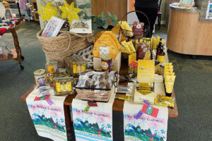 A variety of honey-related items on a table in the gift shop.